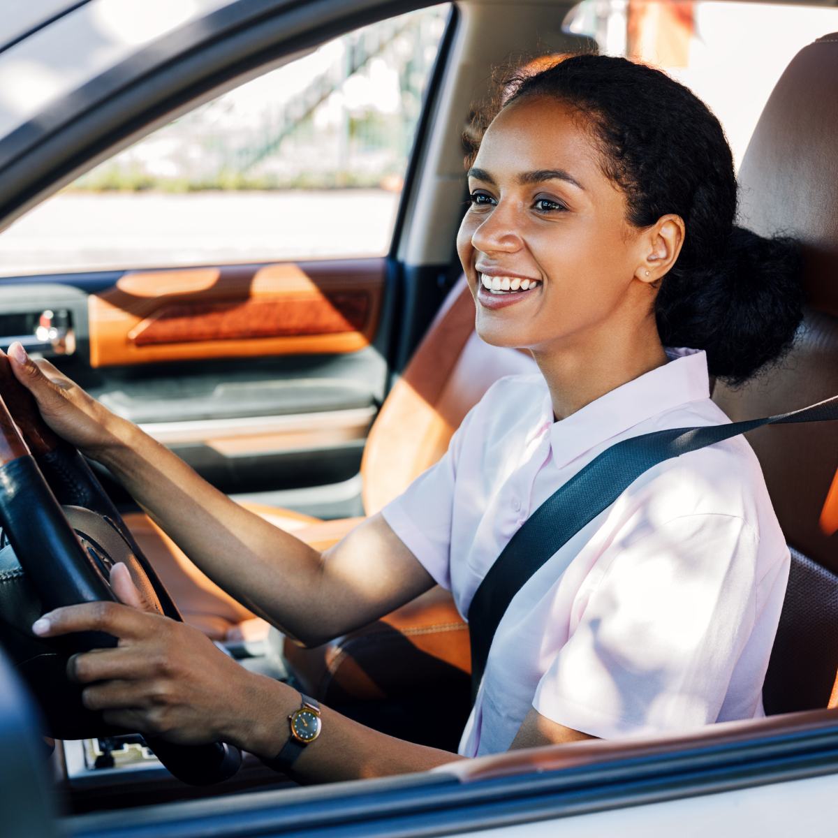 New driver practicing safe driving tips for beginners by familiarizing with vehicle controls in an empty parking lot.